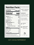 A vertical rectangular nutrition facts label for Grand Provisions Hot Cocoa Peppermint, shown centered on a dark green background. - Image 