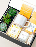 Open gift box filled with curated gifts. - Image 