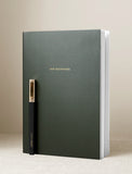 Green journal with black pen. - Image 