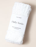 White fuzzy socks on beige background. - Image 