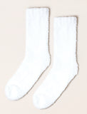 Fuzzy socks on beige background. - Image 