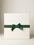 Beige gift box with a green bow. - Image 