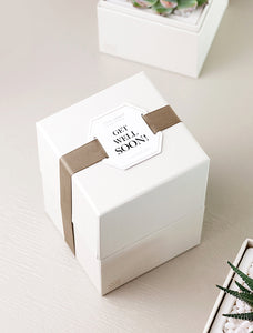 Gift box wrapped in "Get Well Soon!" top tag.