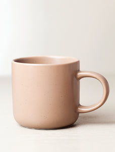 One tan ceramic mug.