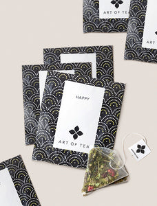 6 Happy Tea bags on table.