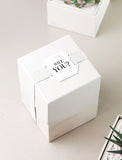 Gift box wrapped in "Will You?" top tag.